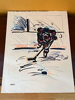 Full view of abstract hockey player painting on paper