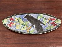 Top view showing crow and ginkgo relief design