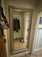 Full view of wall-mounted silver framed mirror