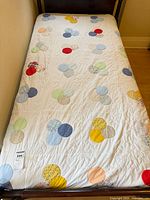 Quilt spread on double bed showing full design