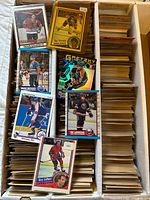 Long box filled with hockey cards, sample top cards visible