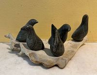 full view of five soapstone birds on antler base