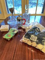Overall lot showing decanters, French press, tea lights, coasters, bottle tags