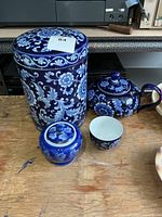 group shot showing canister, teapot, jar with lid, and teacup