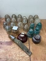 Group shot of glass and porcelain insulators with bracket