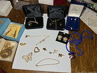 Assorted jewelry laid out showing boxed sets and loose items