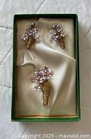 Set showing brooch and earrings in box, front view
