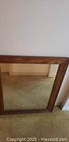 Full view of rectangular mirror with wood frame