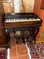 Full view of melodeon showing keyboard, case, stand and pedals