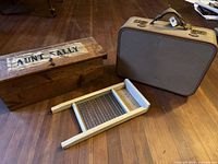 Overall view of washboard, wood box, suitcase