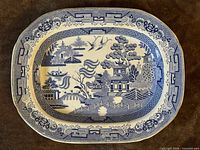 Front view of blue and white willow pattern ironstone platter