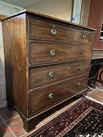 Front view of chest showing five drawers and brass hardware