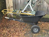 wheelbarrow with hose reel cart resting inside