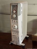 Front view of Garrison oil-filled heater showing controls, fins, wheels