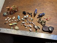 All figurines laid out with ruler for scale