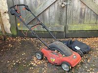 Full view of mower with handle and bag
