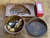 Group shot of mould, ceramic bowl with small items, wooden tray, kokeshi box