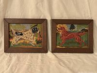 Both framed needlepoint dog pictures side by side