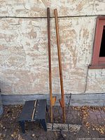 Router table, two wooden braces, wire basket against wall