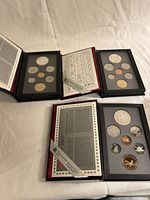 All three proof sets opened to show encapsulated coins