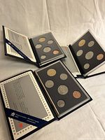 All three RCM coin sets opened to show coin lenses