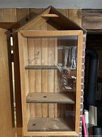 Front view of cedar cabinet showing glass door and three shelves