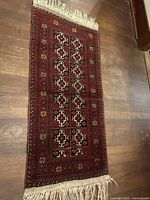 Full view of rug showing overall design, borders and fringe