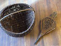Bellows and wicker basket together on floor