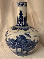 Full view showing bulbous body, long neck and painted motifs