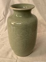Full view of celadon vase front showing floral motif