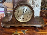 Front view of oak mantel clock showing dial and case