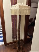Full view of wooden floor lamp with shade