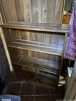 Front view of solid wood side table showing four shelves