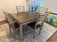 complete table with four chairs on rug