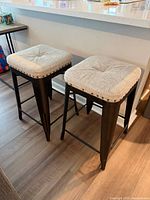 Two fabric top bar stools beside counter