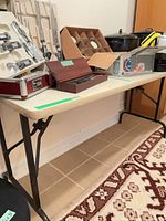 Table surface with various items on top showing overall shape and color