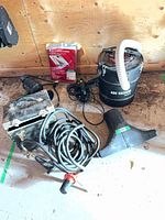 Group shot of ash vacuum, electric motor, cords, accessories