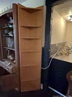 Full view of corner display cabinet showing height and shelf configuration