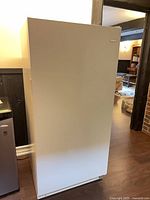 Front view of white Frigidaire upright freezer
