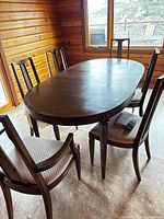 Six glazed cherry wood dining chairs around table