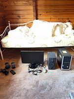 Group shot showing PC tower, monitor, subwoofer, speakers, mouse, remote, cables