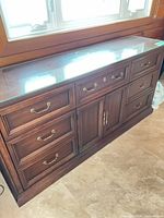 Full view of mahogany veneer dresser under window