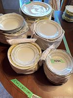 Stacks of wrapped plates and bowls on table