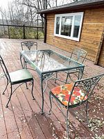 Full view of table and four chairs on deck