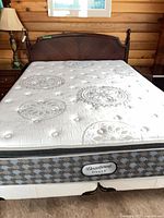 Full view of queen bed showing headboard, mattress, box spring