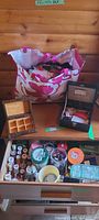 Drawer with thread spools, buttons, Singer box, magnifier