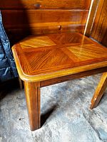 Overall view of oak side table next to wall