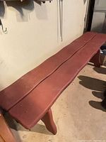 Angled view of bench showing length and red distressed finish