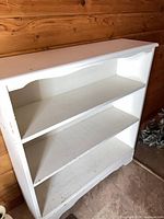 Front view of white solid wood cabinet with two shelves