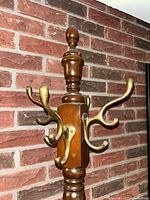 top section showing brass-tone hooks and finial